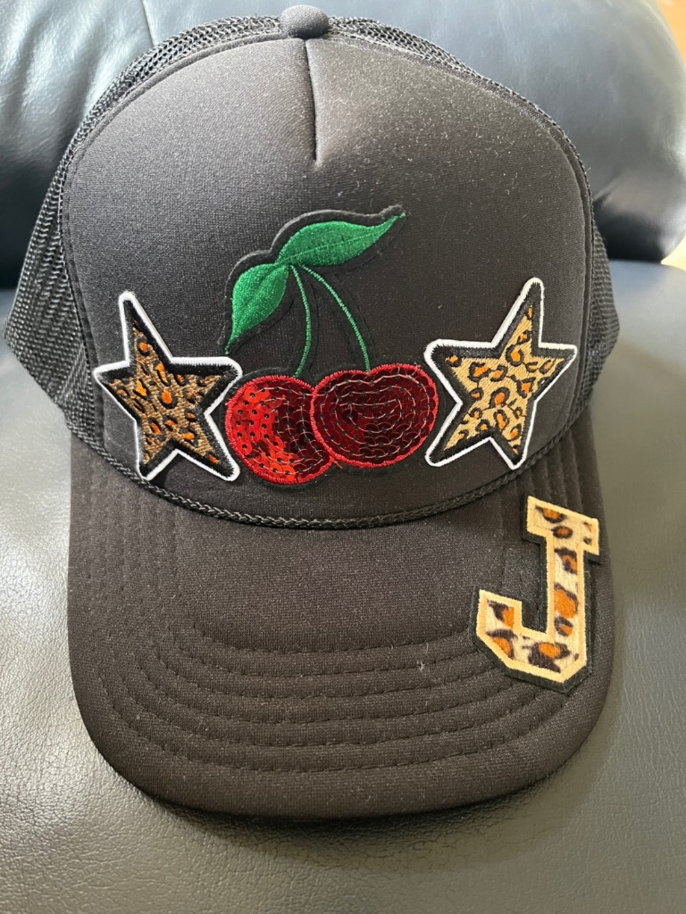 Black Trucker Hat with Red Cherry & Leopard Star Patches